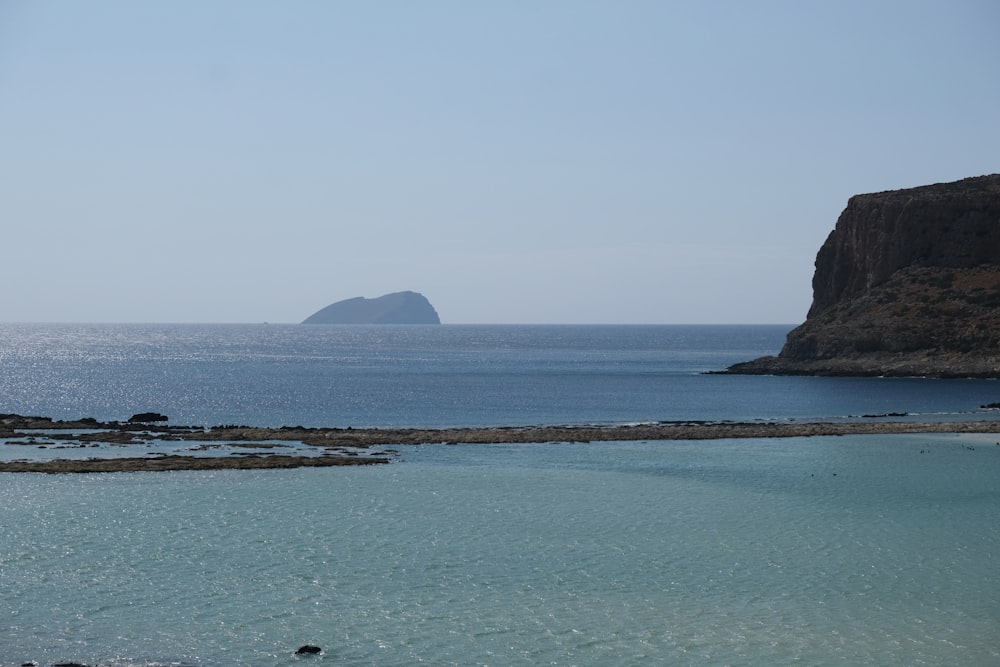 a body of water with a small island in the distance