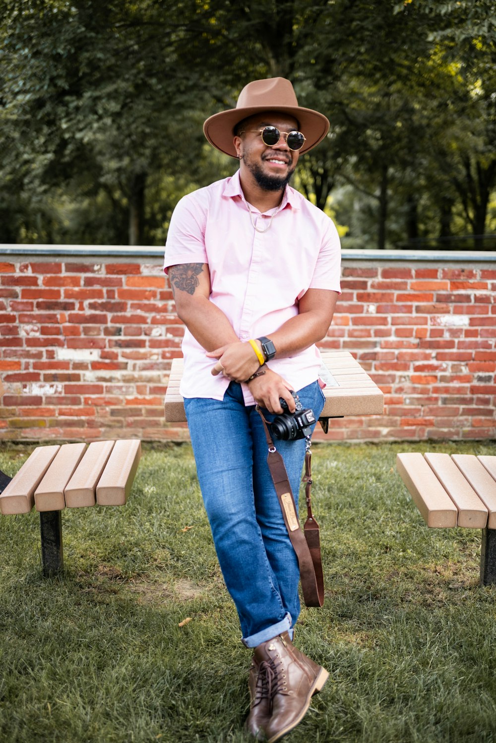 a man sitting on a bench with a camera