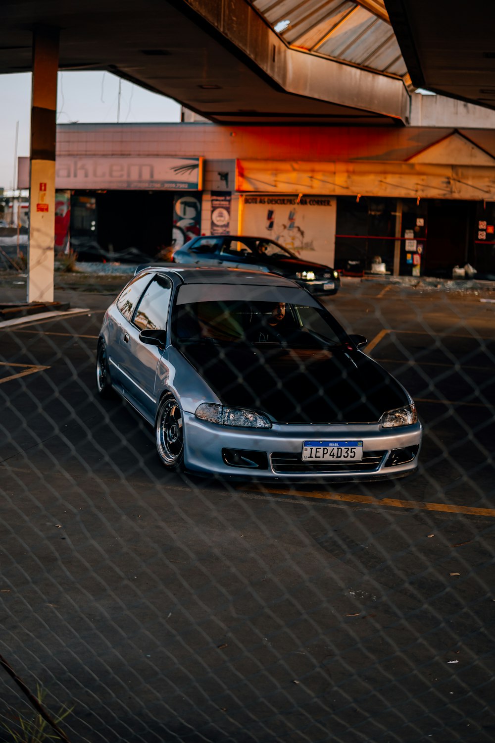 a car parked in a parking lot next to a building