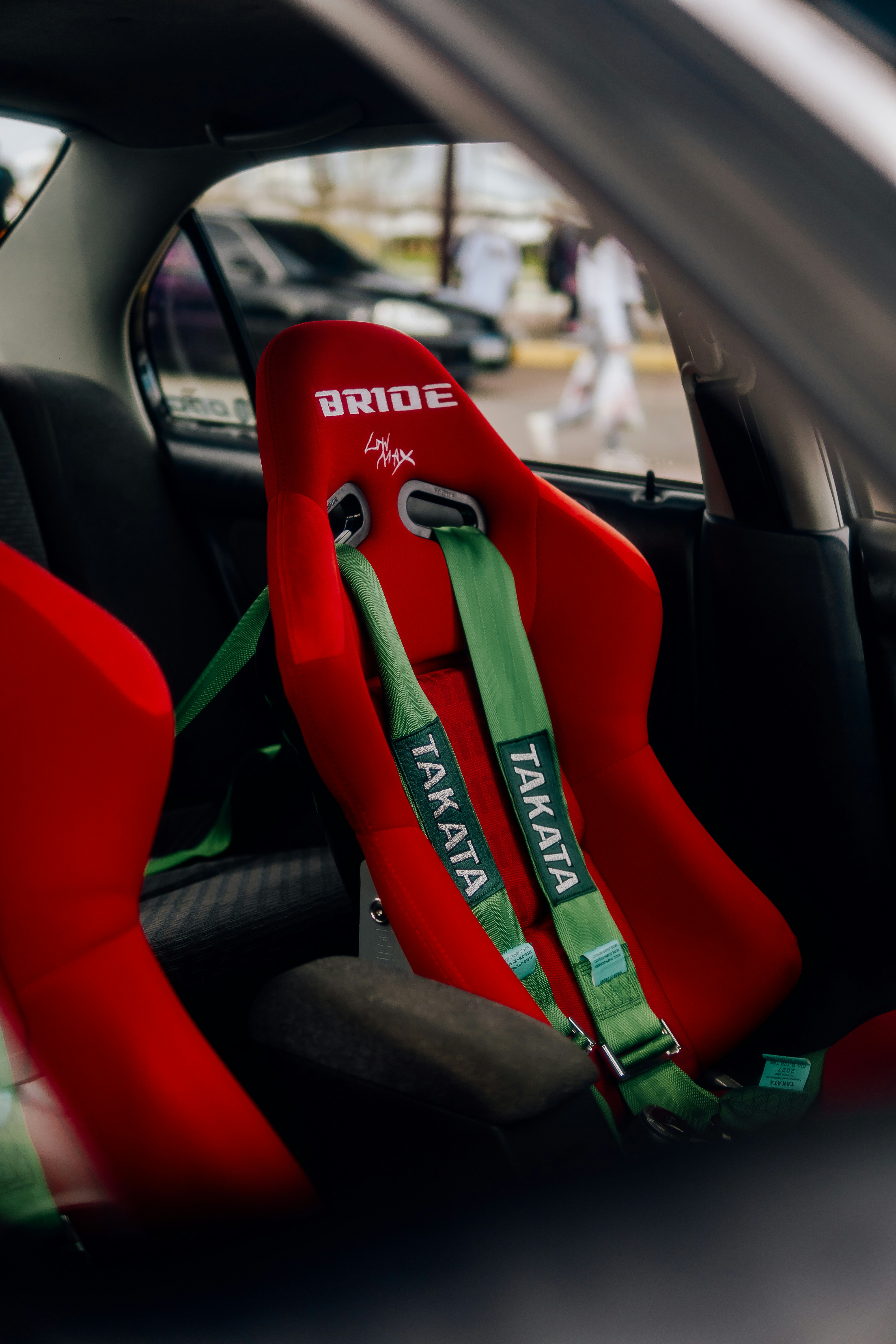 VelocityX racing bucket seats in red alcantara with harness