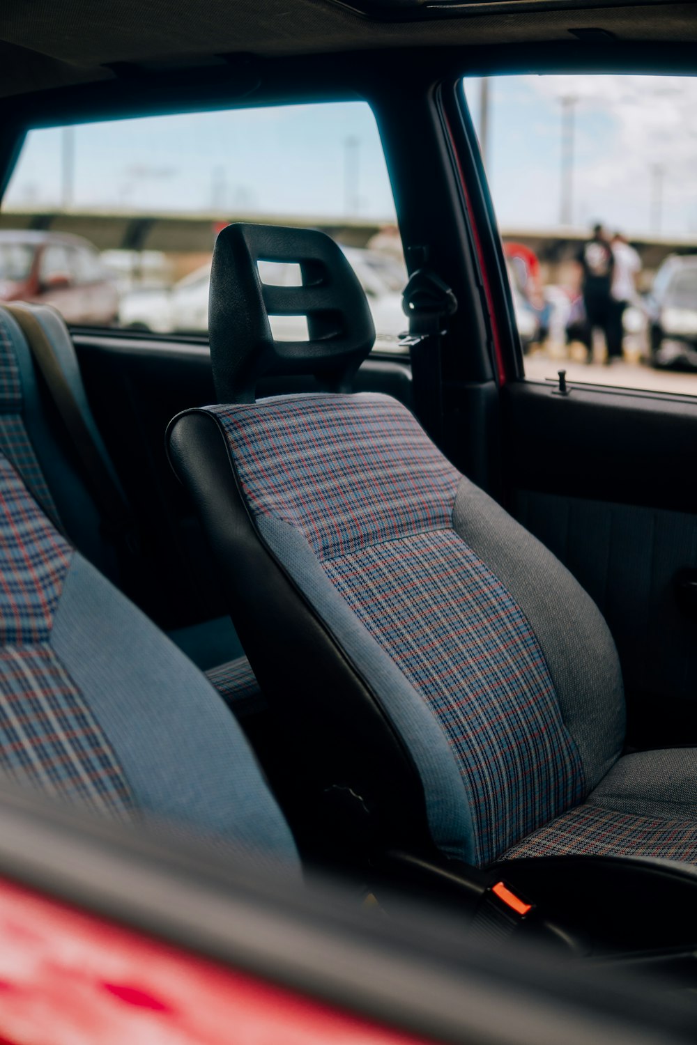 the interior of a car with a checkered seat cover