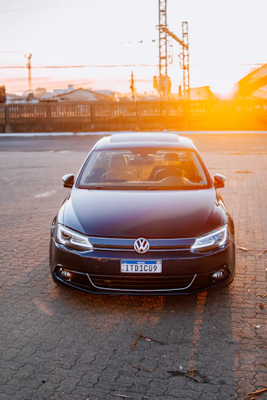 A vibrant photo of a sleek rental car parked by a sunny Brazilian beach.