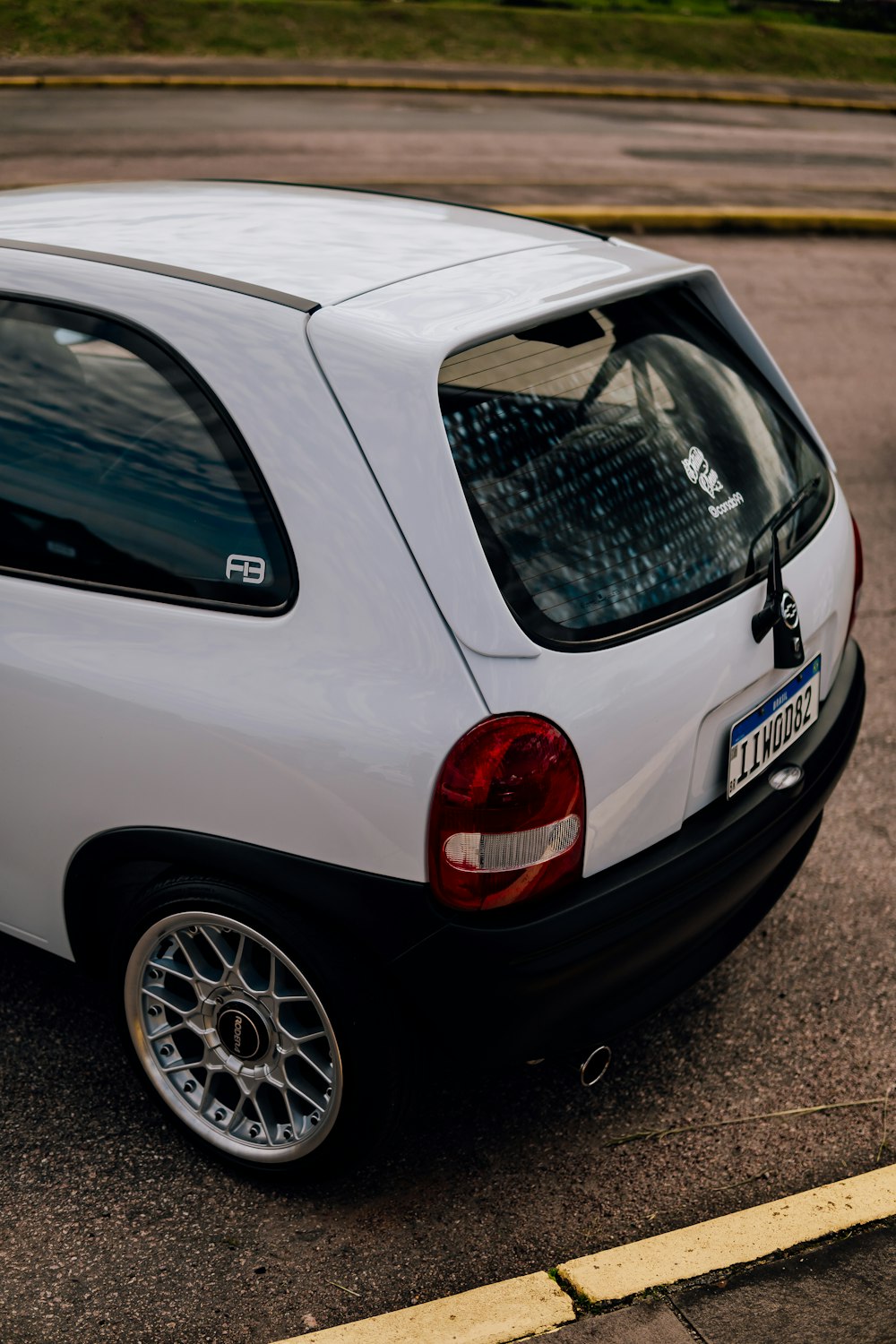 a small white car parked in a parking lot