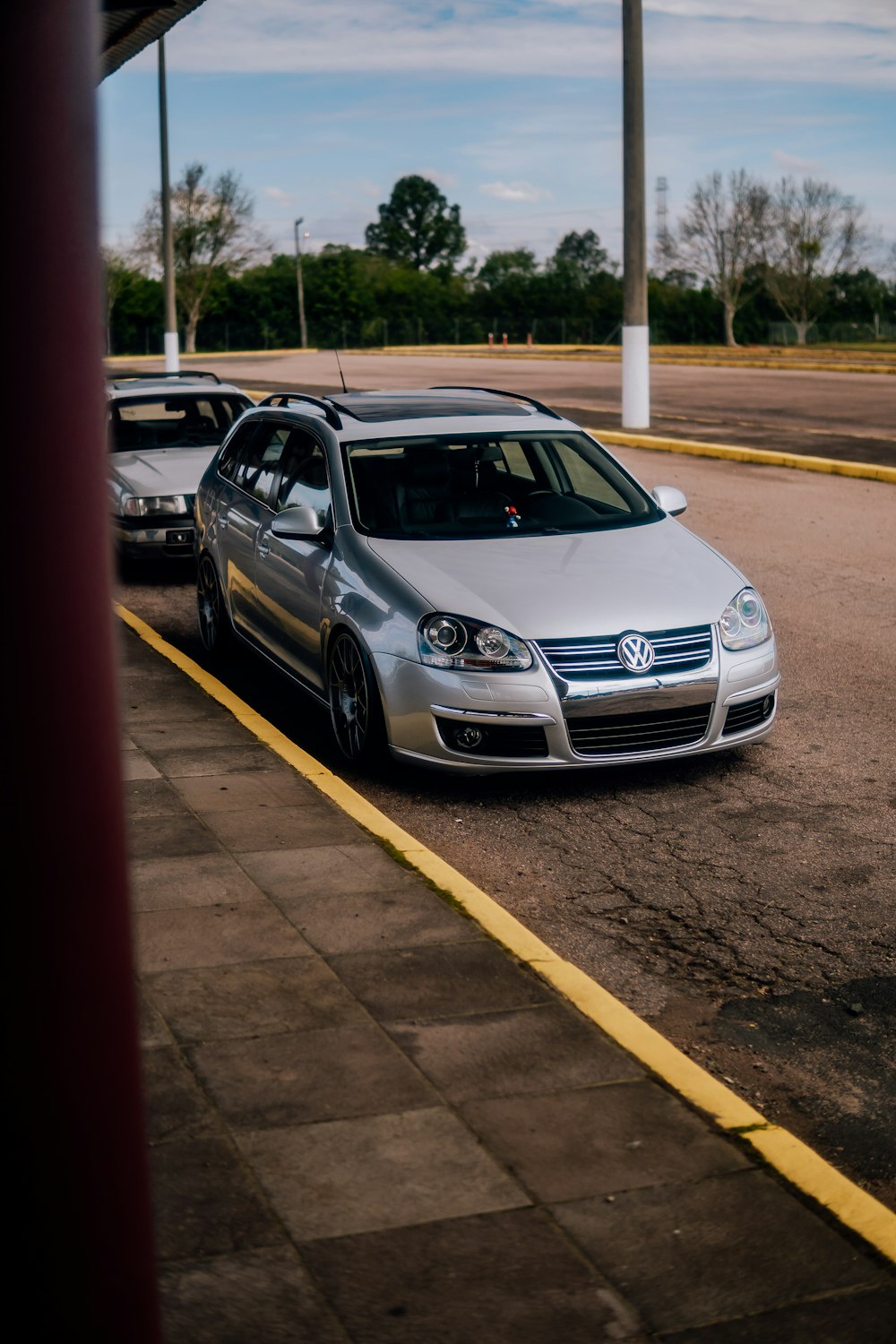 two cars parked in a parking lot next to each other