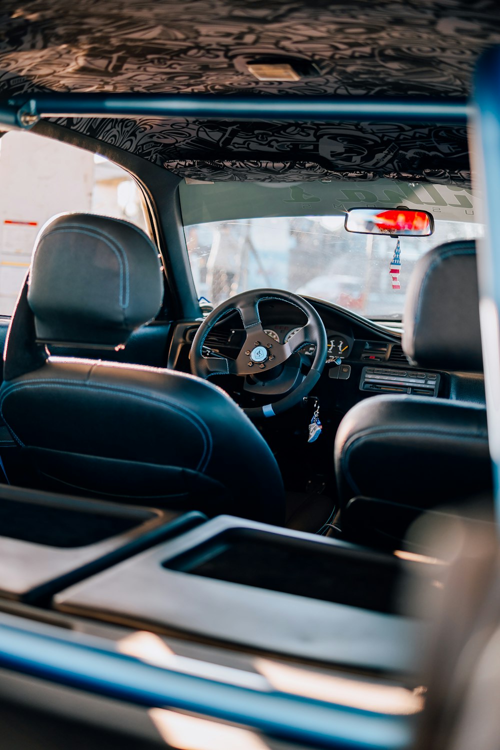 the interior of a vehicle with a steering wheel and dashboard