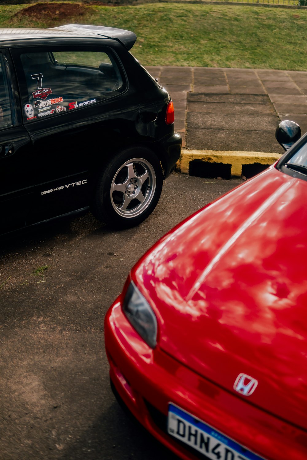 a red car parked next to a black car