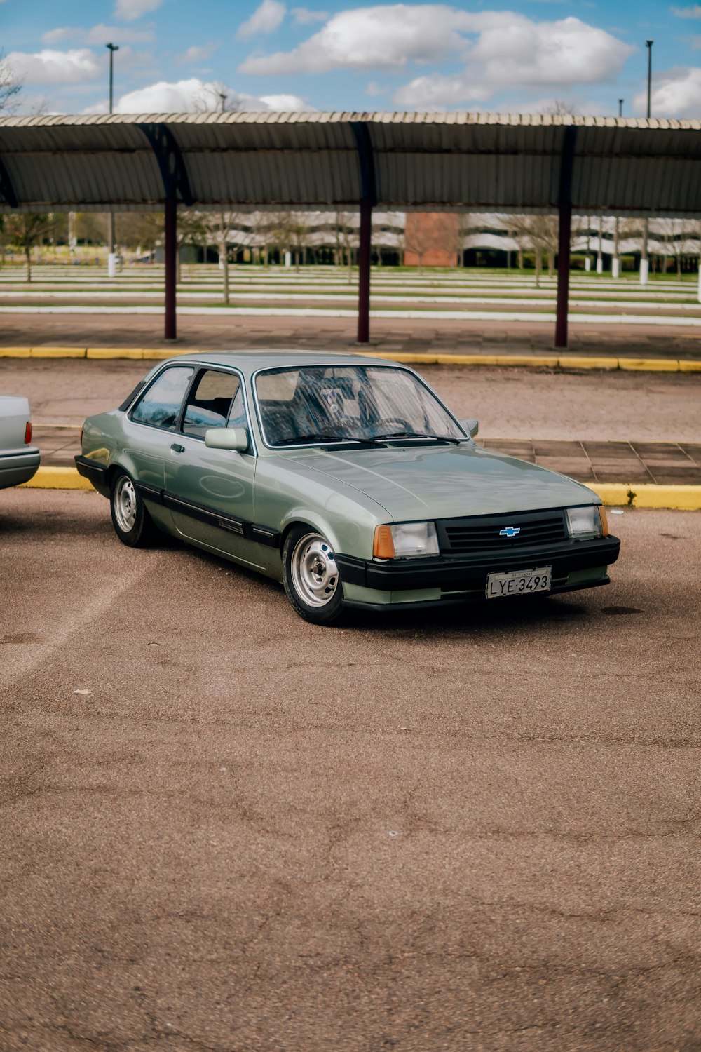 a green car parked in a parking lot