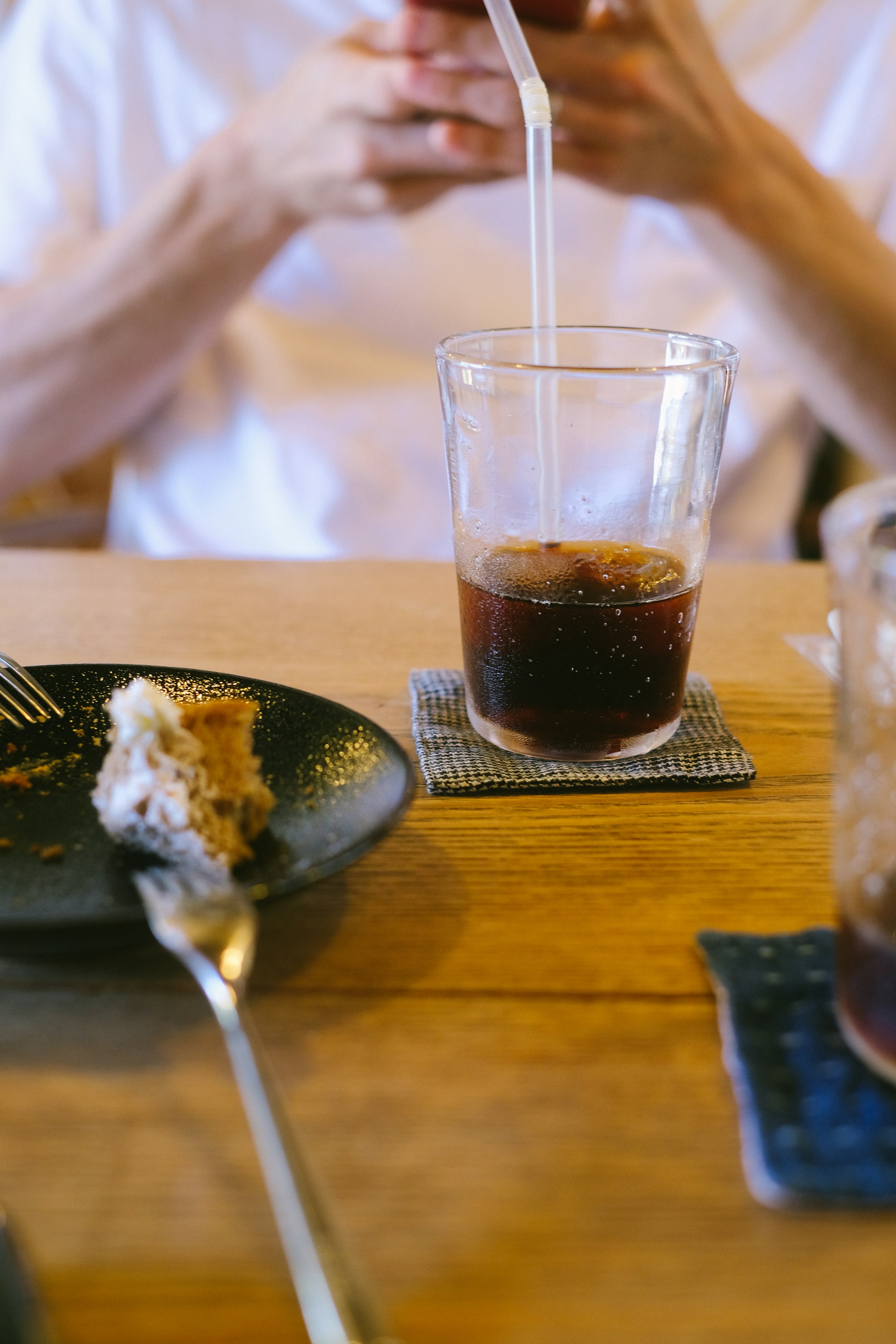 a person sitting at a table with a plate of food