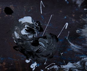 Black and white abstract painting with bold brush strokes.