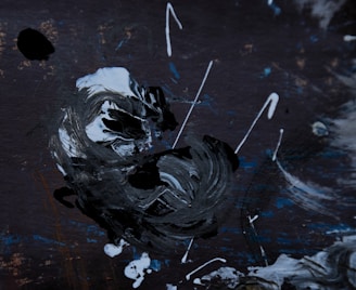 A striking black and white abstract painting with bold brush strokes and sharp contrasts.