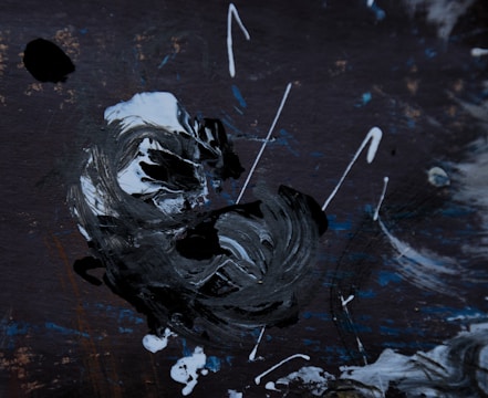 Black and white abstract painting with bold brush strokes.