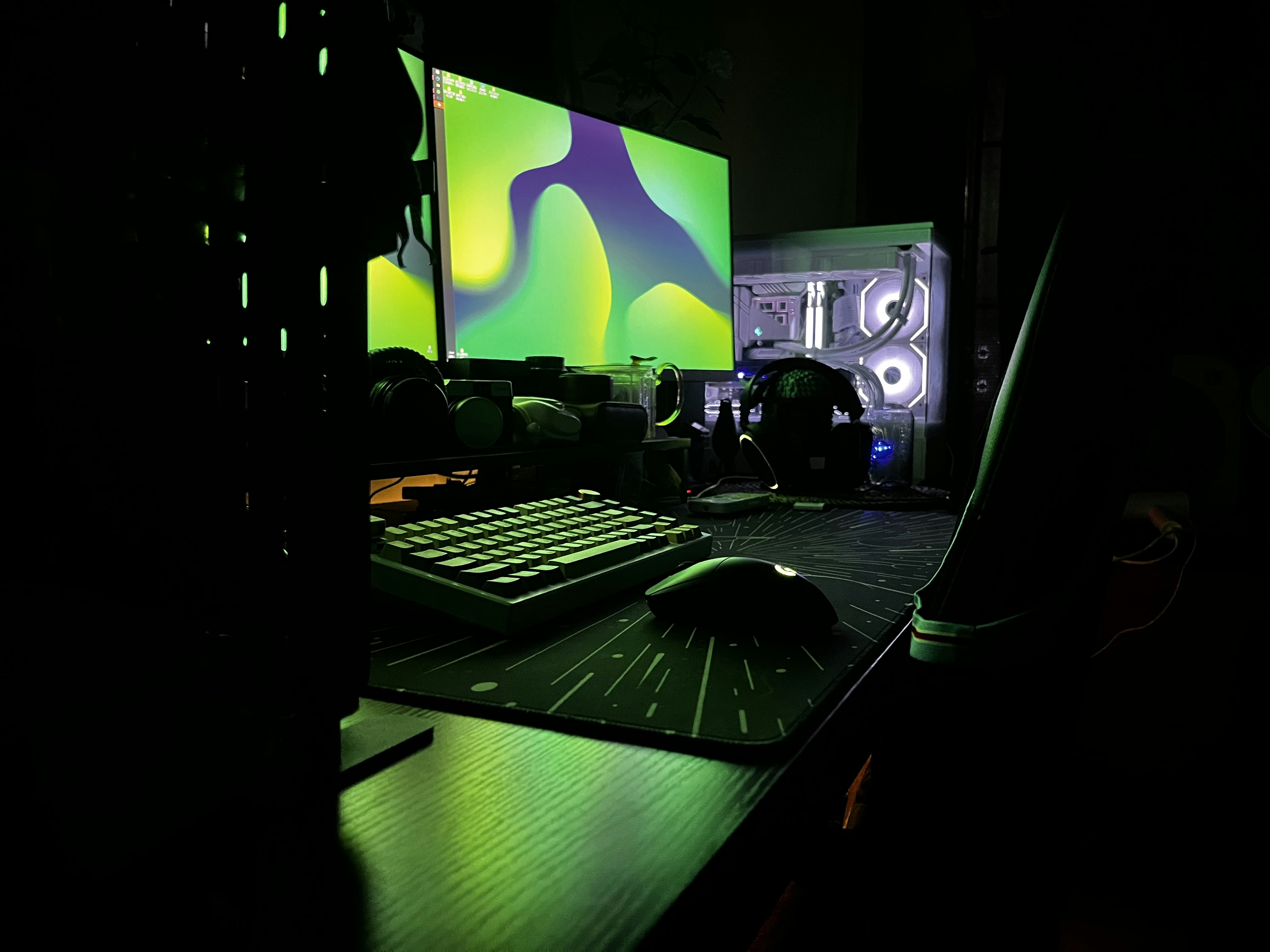 Dark gaming environment, glowing screens, moody atmospheric lighting with green hues, dim shadows