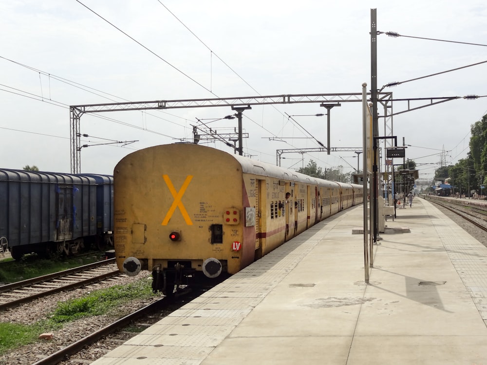 a yellow train is pulling into a train station