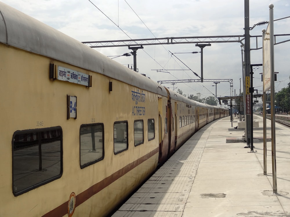 a yellow train stopped at a train station