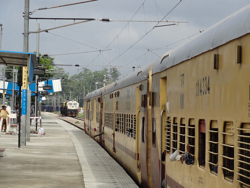 a yellow train stopped at a train station