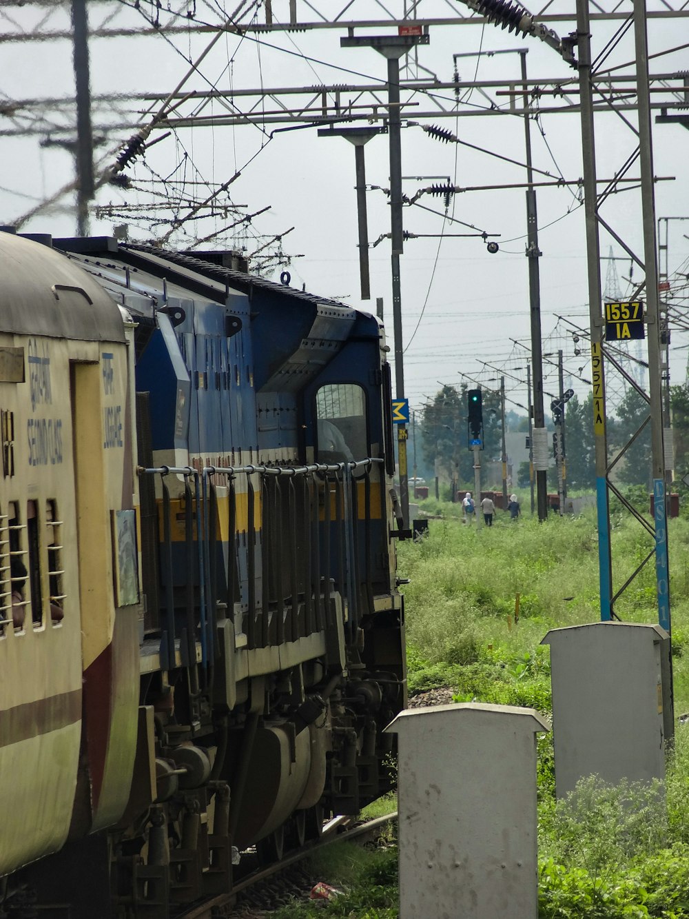 a blue and yellow train traveling down train tracks