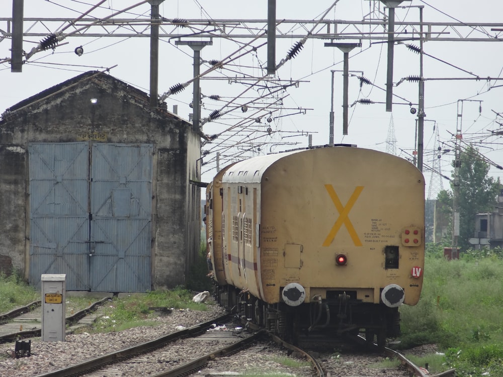 a train on a train track next to a building