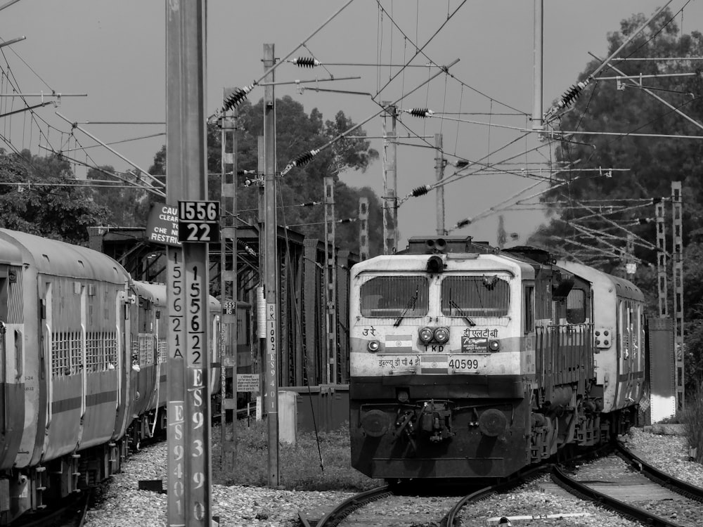 a black and white photo of a train on the tracks