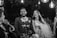 A joyful wedding celebration with a DJ and vibrant lighting.