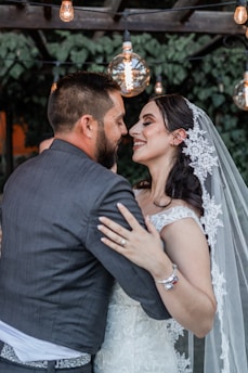 A videographer capturing a joyful moment at a wedding ceremony.