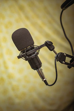 Close-up of a professional microphone with sound waves illustrating voice modulation.