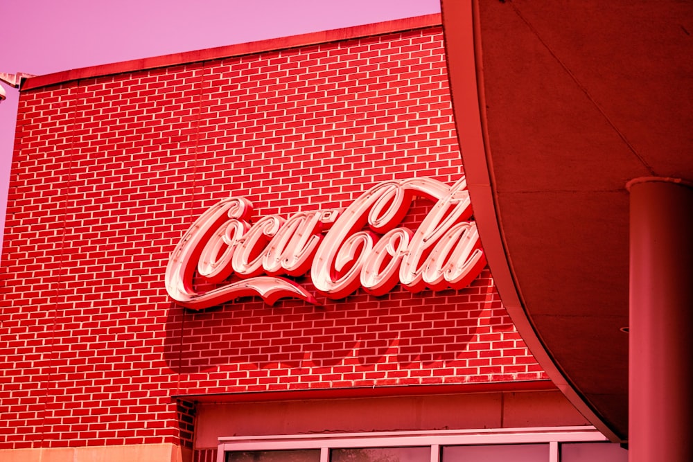 a red brick building with a coca cola sign on it