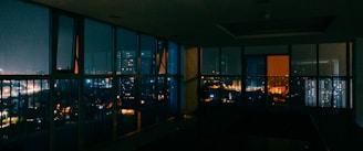 A sleek, dark-themed office space with cityscape views of Nairobi at dusk, reflecting a private and exclusive atmosphere.