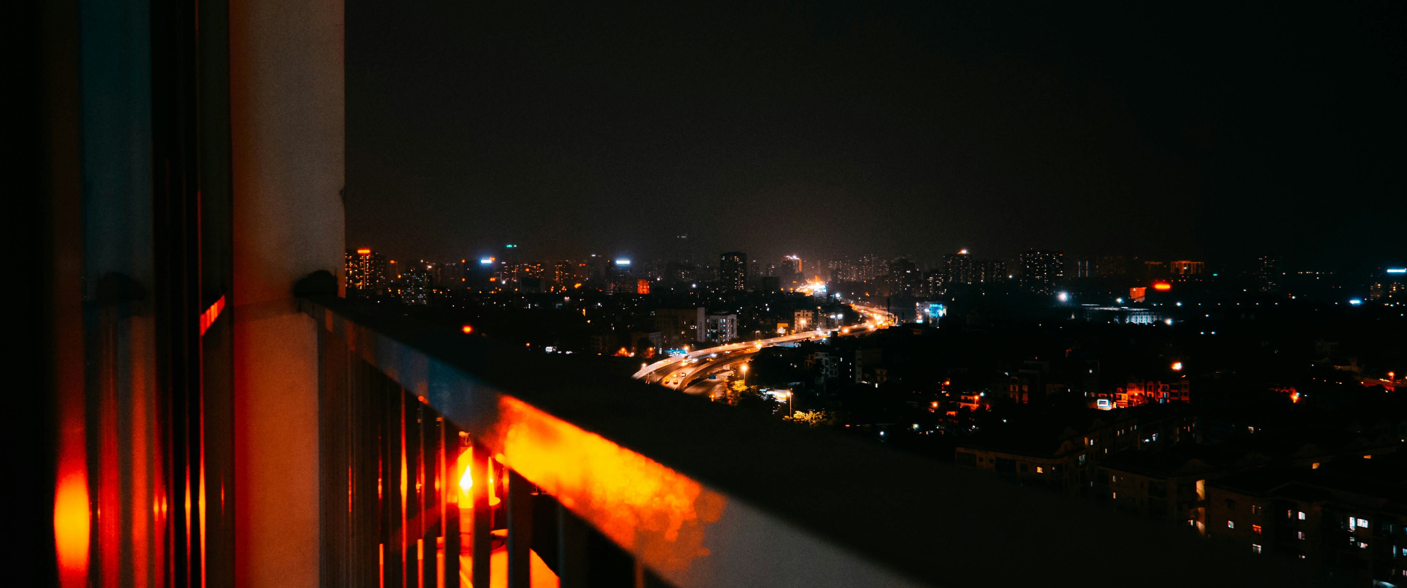 a view of a city at night from a balcony