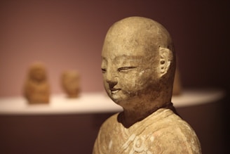 Clay sculpture installed inside a serene church setting, capturing a peaceful spiritual figure.