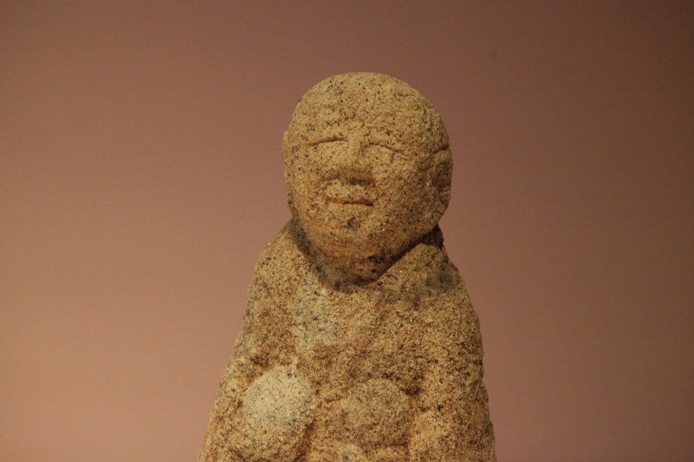 a stone statue of a person with a scarf around his neck