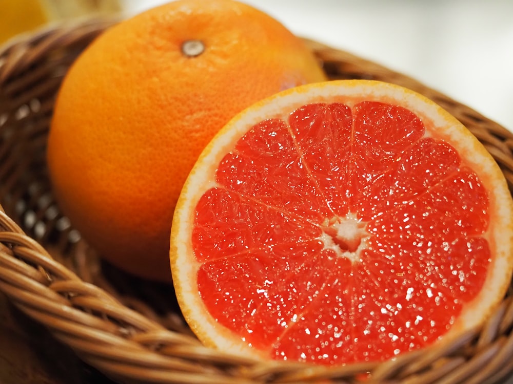 a grapefruit and a grapefruit in a basket