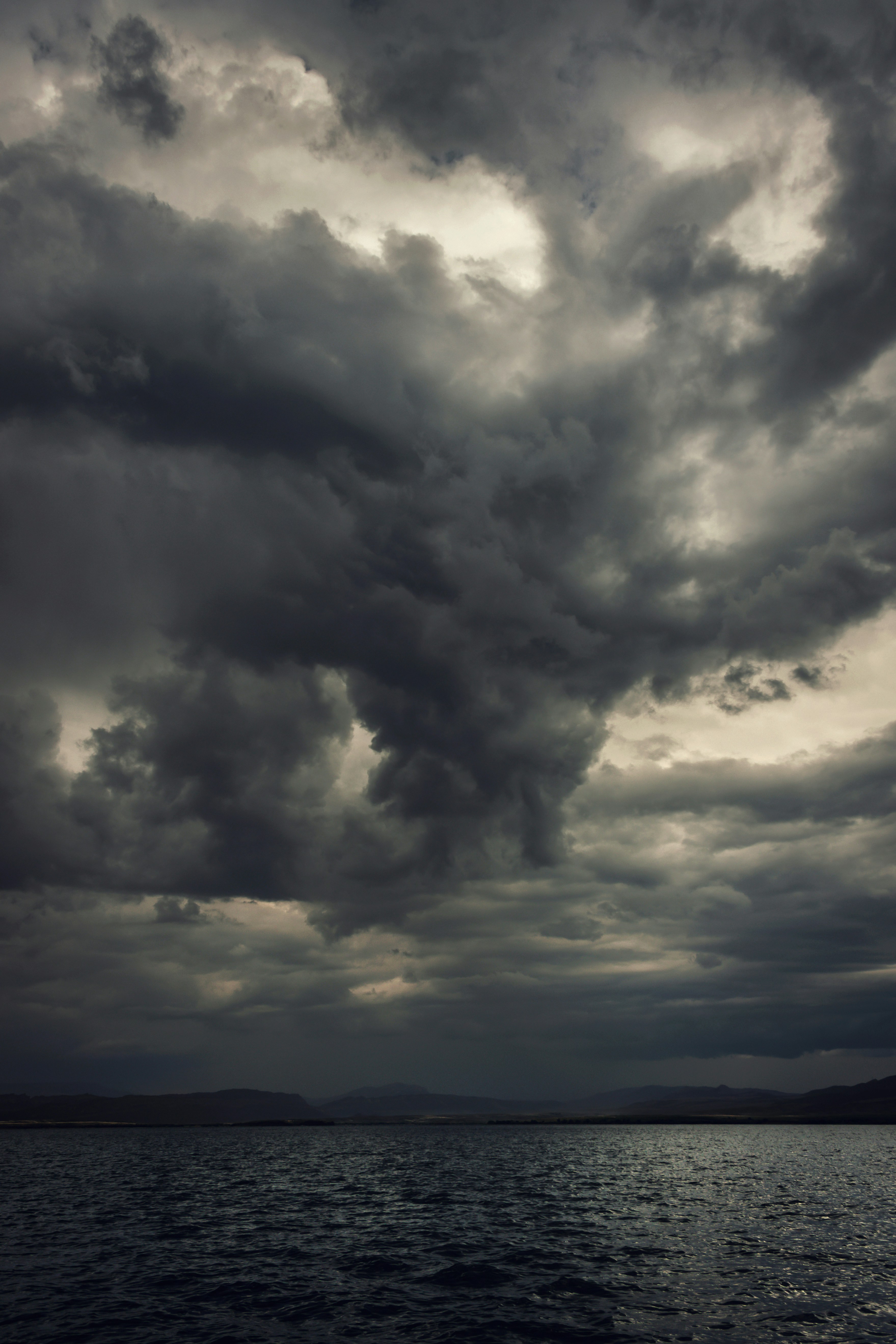 a large body of water under a cloudy sky