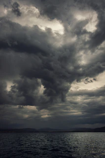 a large body of water under a cloudy sky