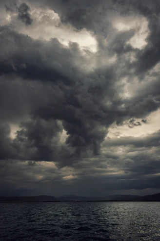 a large body of water under a cloudy sky