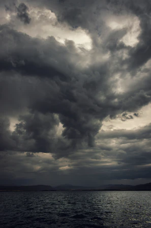 a large body of water under a cloudy sky