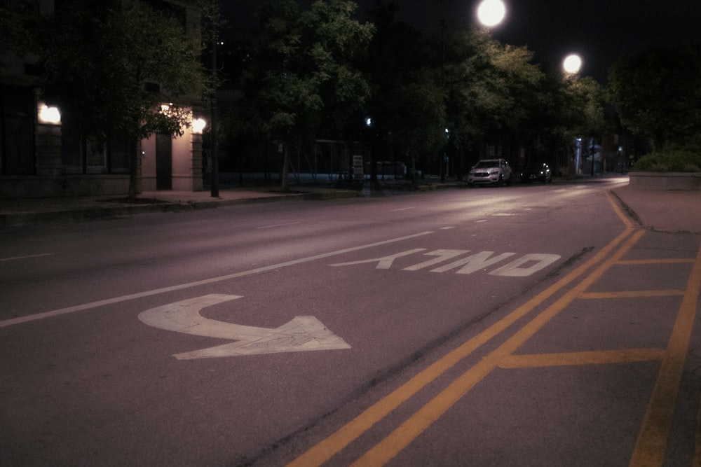 an empty street with a street sign on the side of it