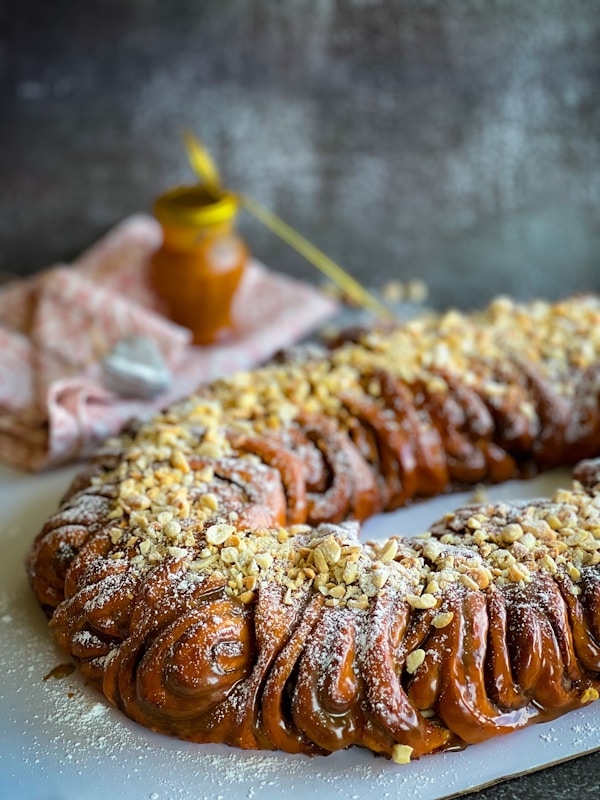 A pastry with nuts on a white plate