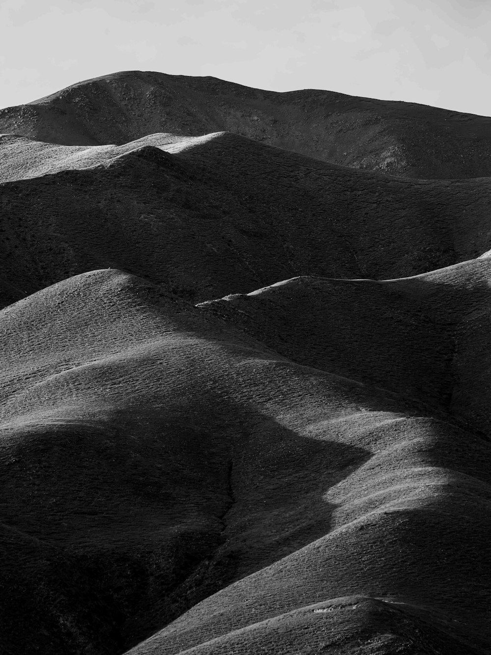 a black and white photo of a mountain range