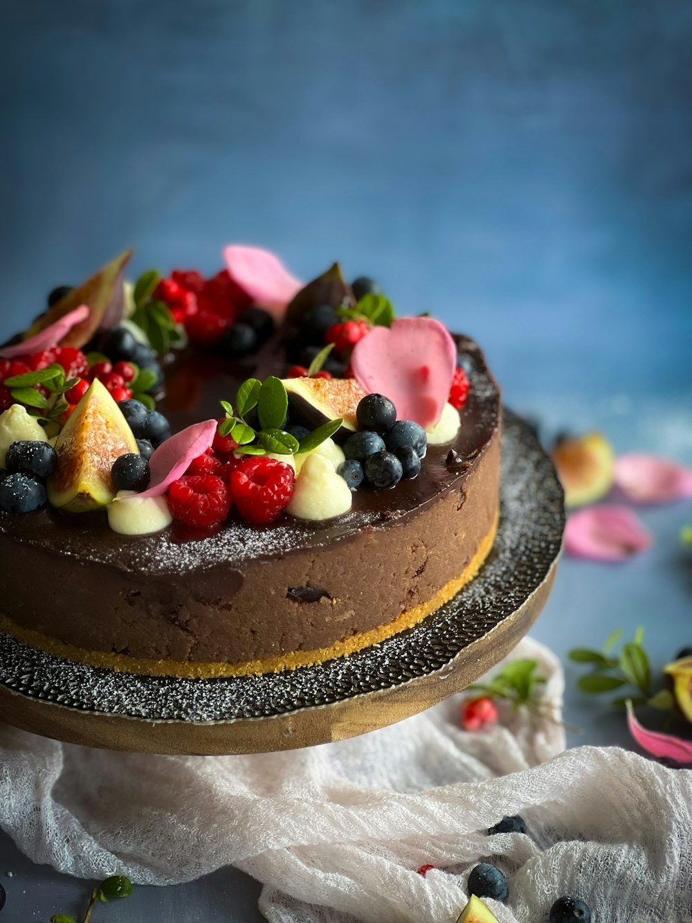 a chocolate cake topped with berries and other toppings