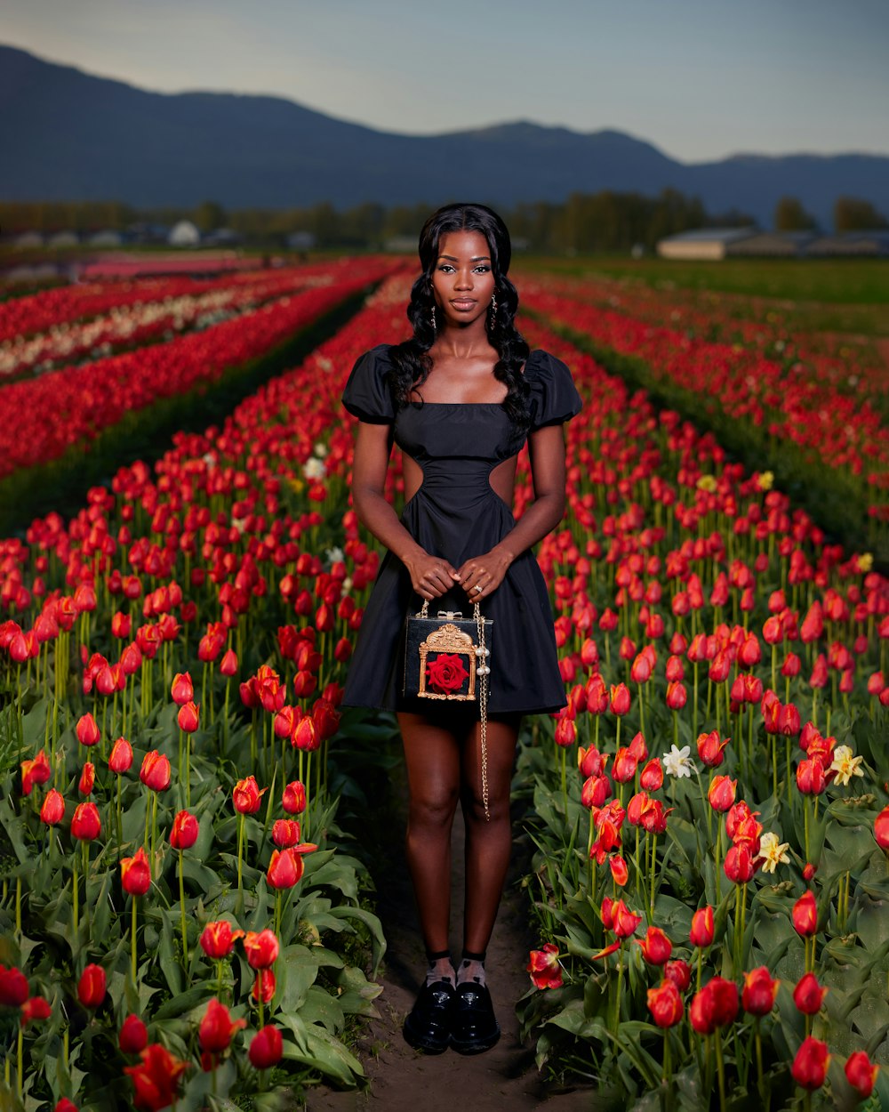 a woman standing in a field of flowers