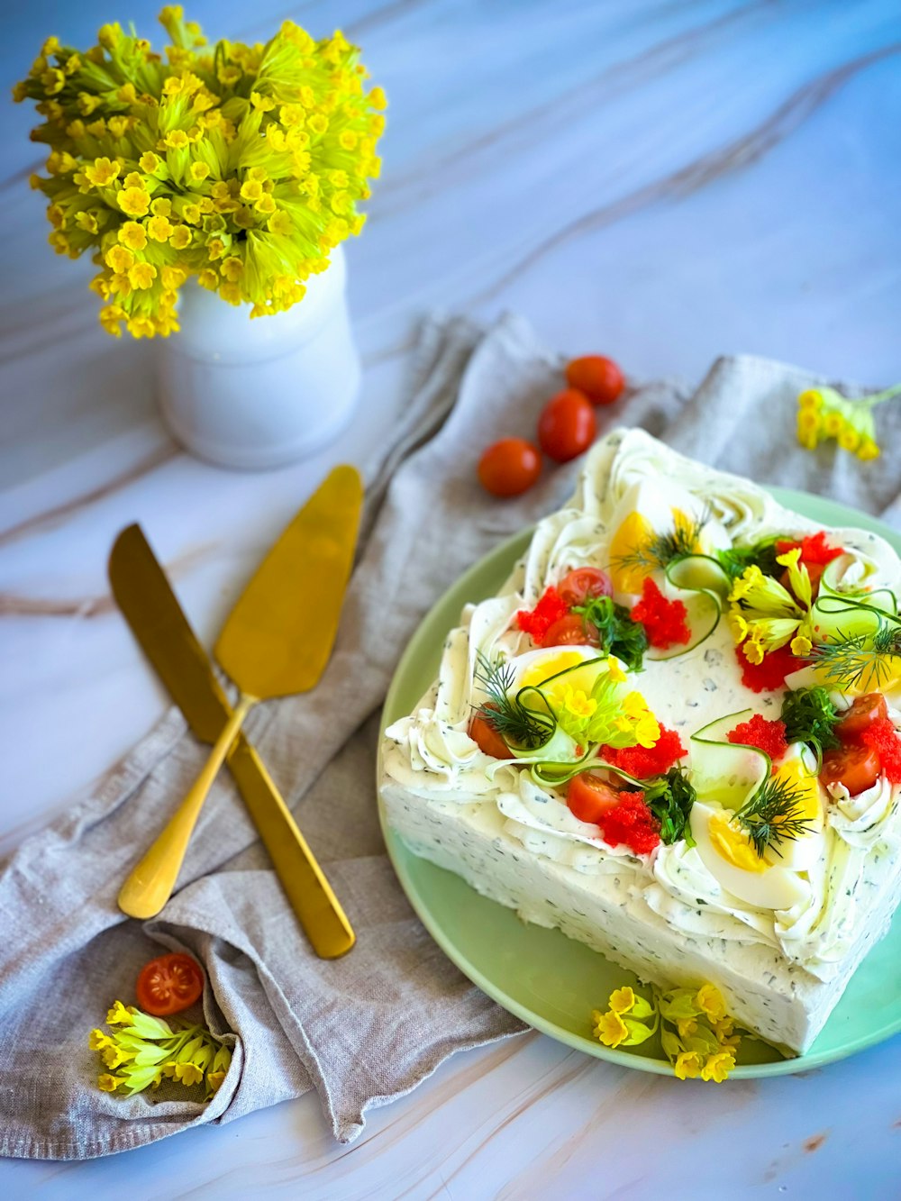 a plate with a cake on it next to a vase of flowers