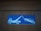 A pictogram on a blue background depicts a tow truck pulling a car. The design is simple with the vehicles shown in white outlines against a vibrant blue rectangle. Both vehicles are oriented in a profile view, clearly illustrating the towing action.