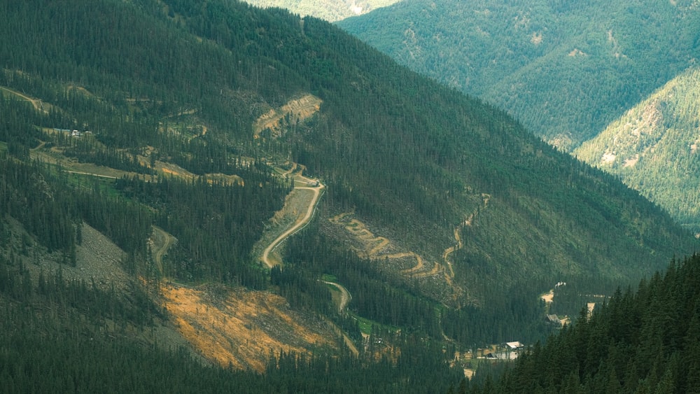 a scenic view of a winding road in the mountains