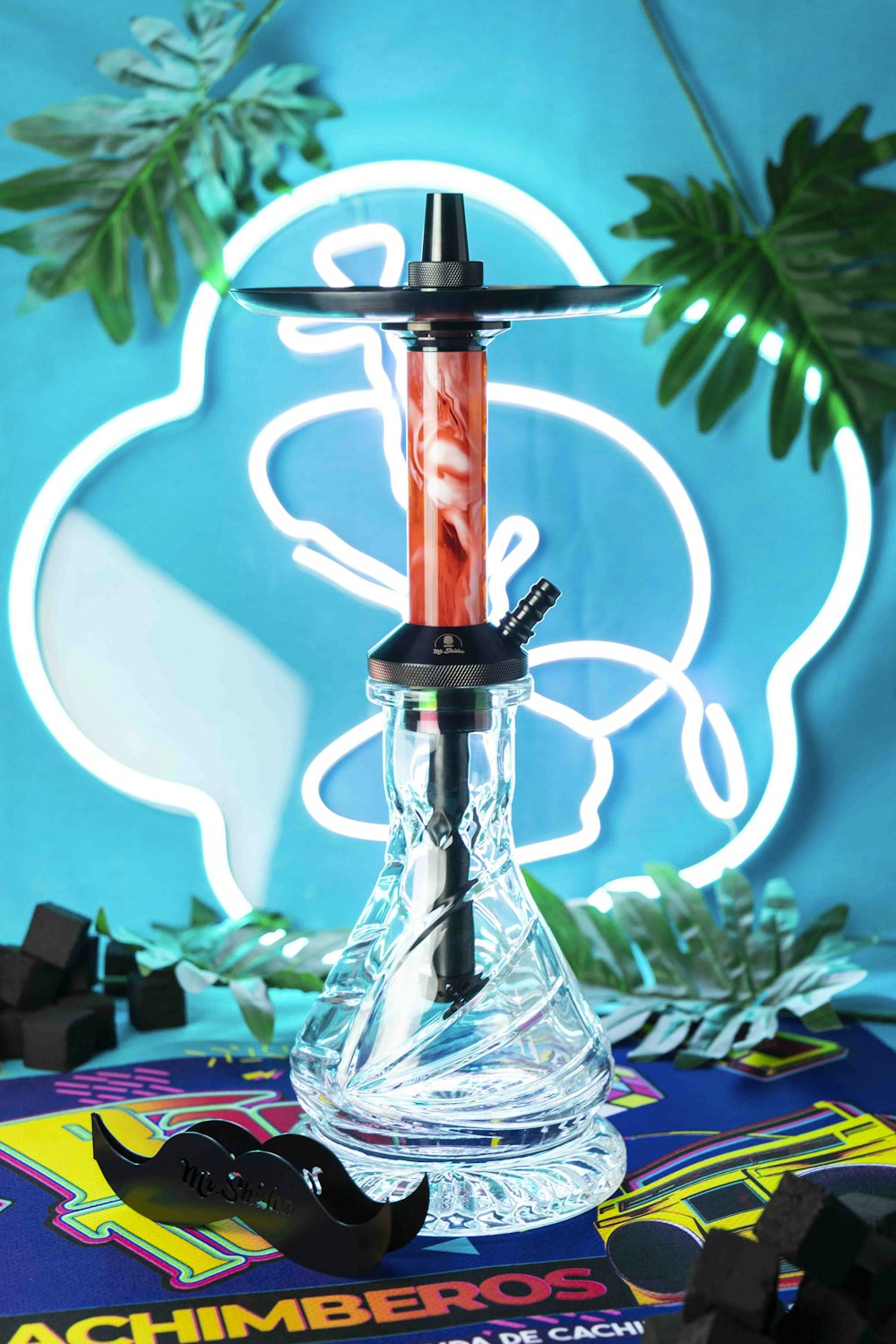 a glass hookah with a red liquid in it
