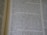 A close-up view of an open book displaying printed text in a column layout. The text appears to be a narrative or a passage from literature, with organized formatting and clear print.