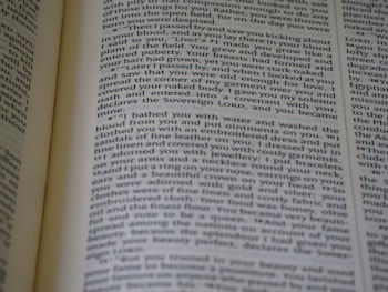 A close-up view of an open book displaying printed text in a column layout. The text appears to be a narrative or a passage from literature, with organized formatting and clear print.