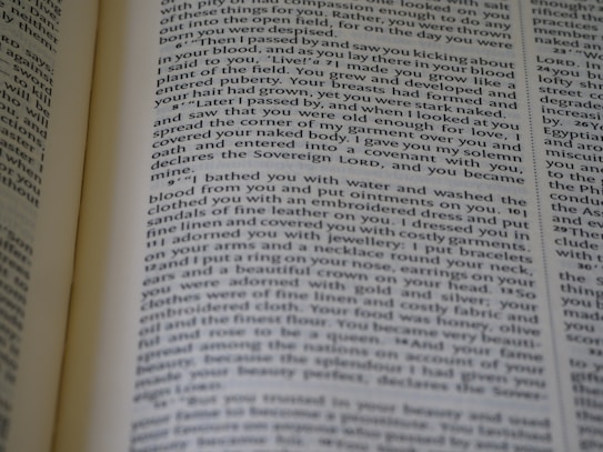 A close-up view of an open book displaying printed text in a column layout. The text appears to be a narrative or a passage from literature, with organized formatting and clear print.