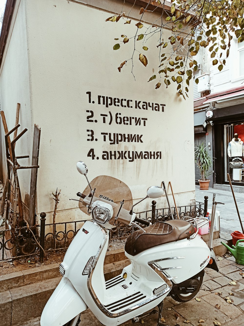 a white scooter parked in front of a building