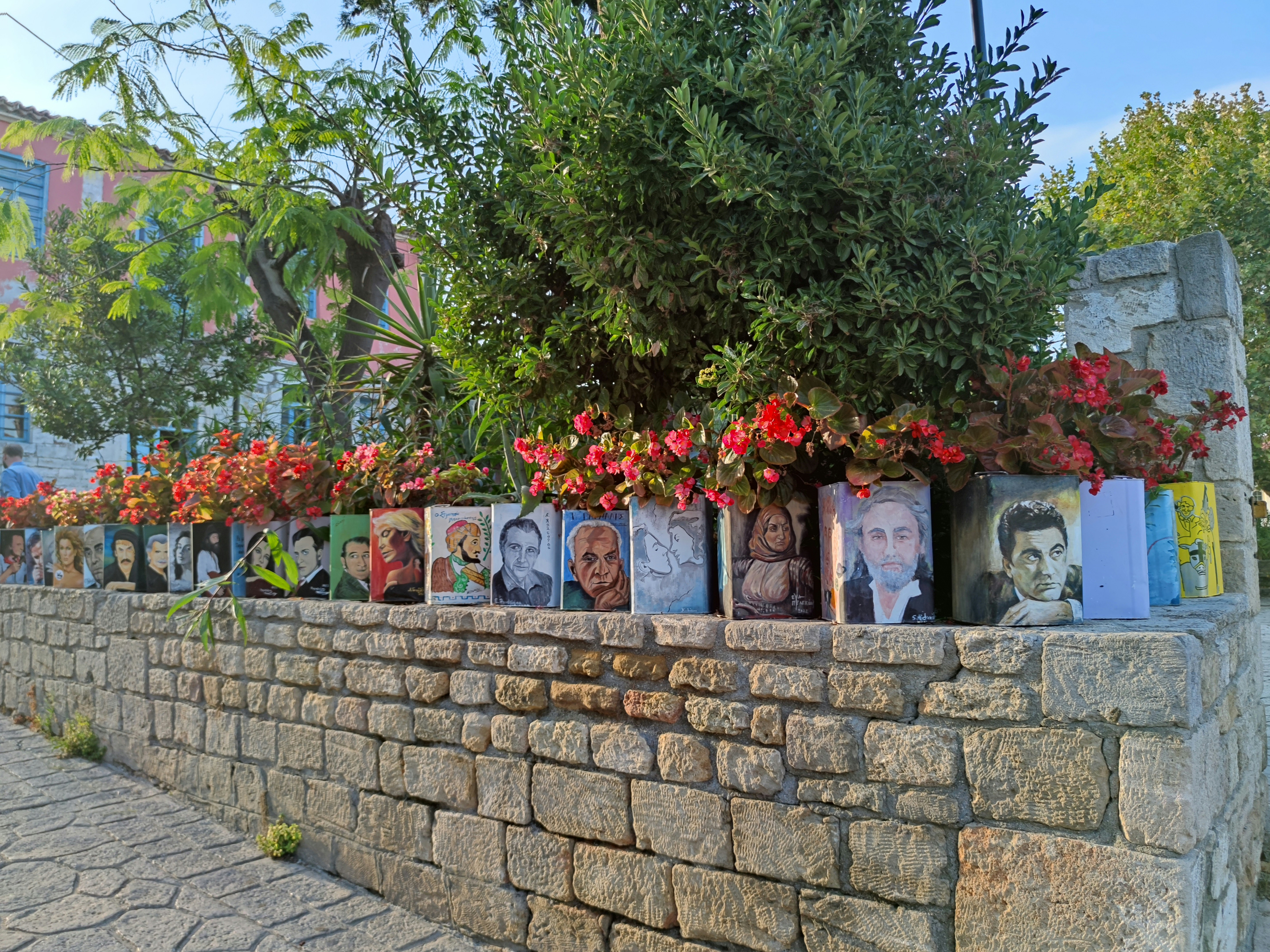a stone wall with flowers and pictures on it
