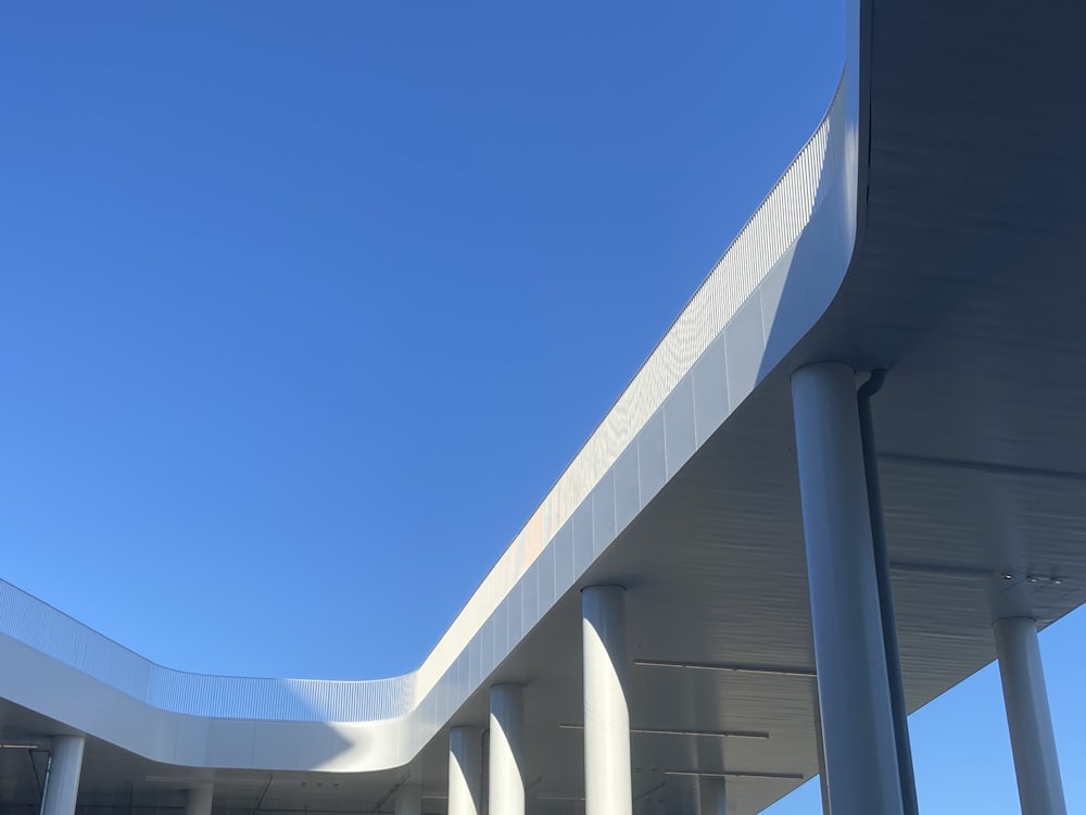 the underside of a bridge against a blue sky